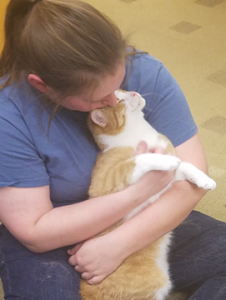 HSHV Staff member kissing and snuggling Finn the cat