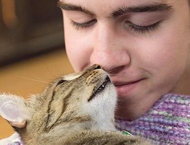 young man with cat at campurrs