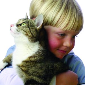 Young boy with pet cat in arm