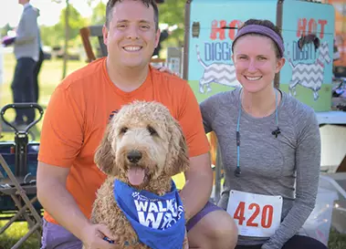 A man and a woman and their dog at Walk and Wag